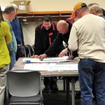 people working on a project around a table