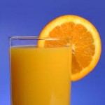 glass of orange juice with an orange slice