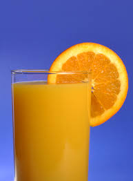 glass of orange juice with an orange slice