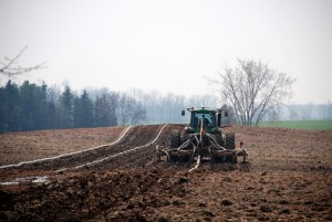 a person in a tractor doing field work