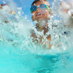 boy being splashed in waterpark