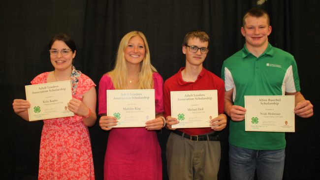 4-H members are displaying their certificates for the scholarships they earned.